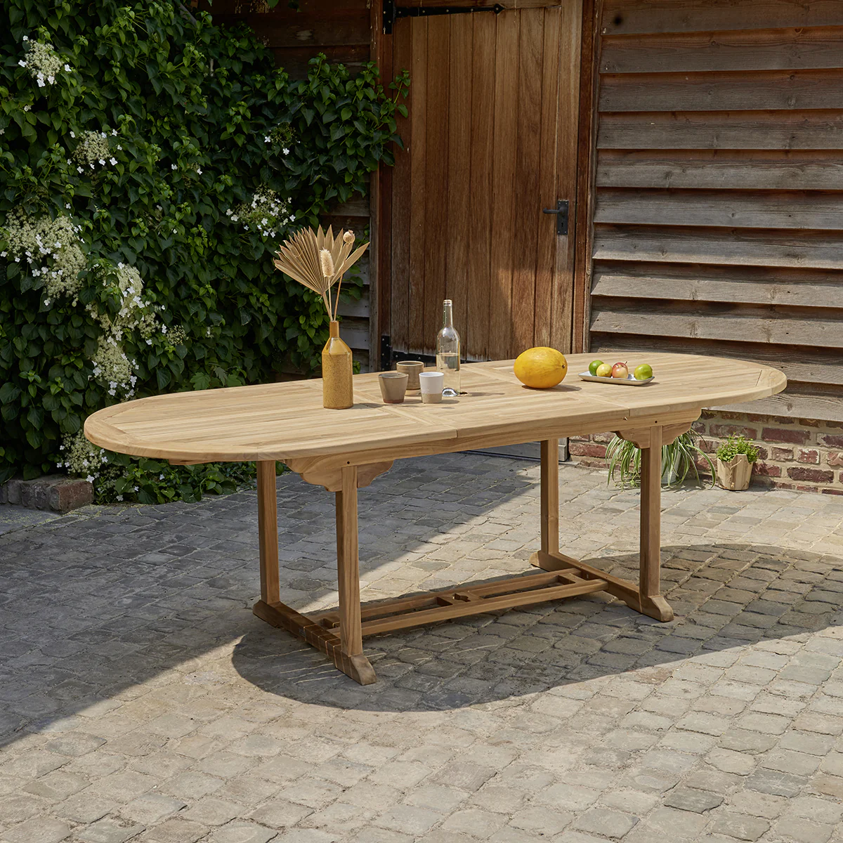 Mesa de exterior ovalada extensible de teca maciza para 8/10 pers.